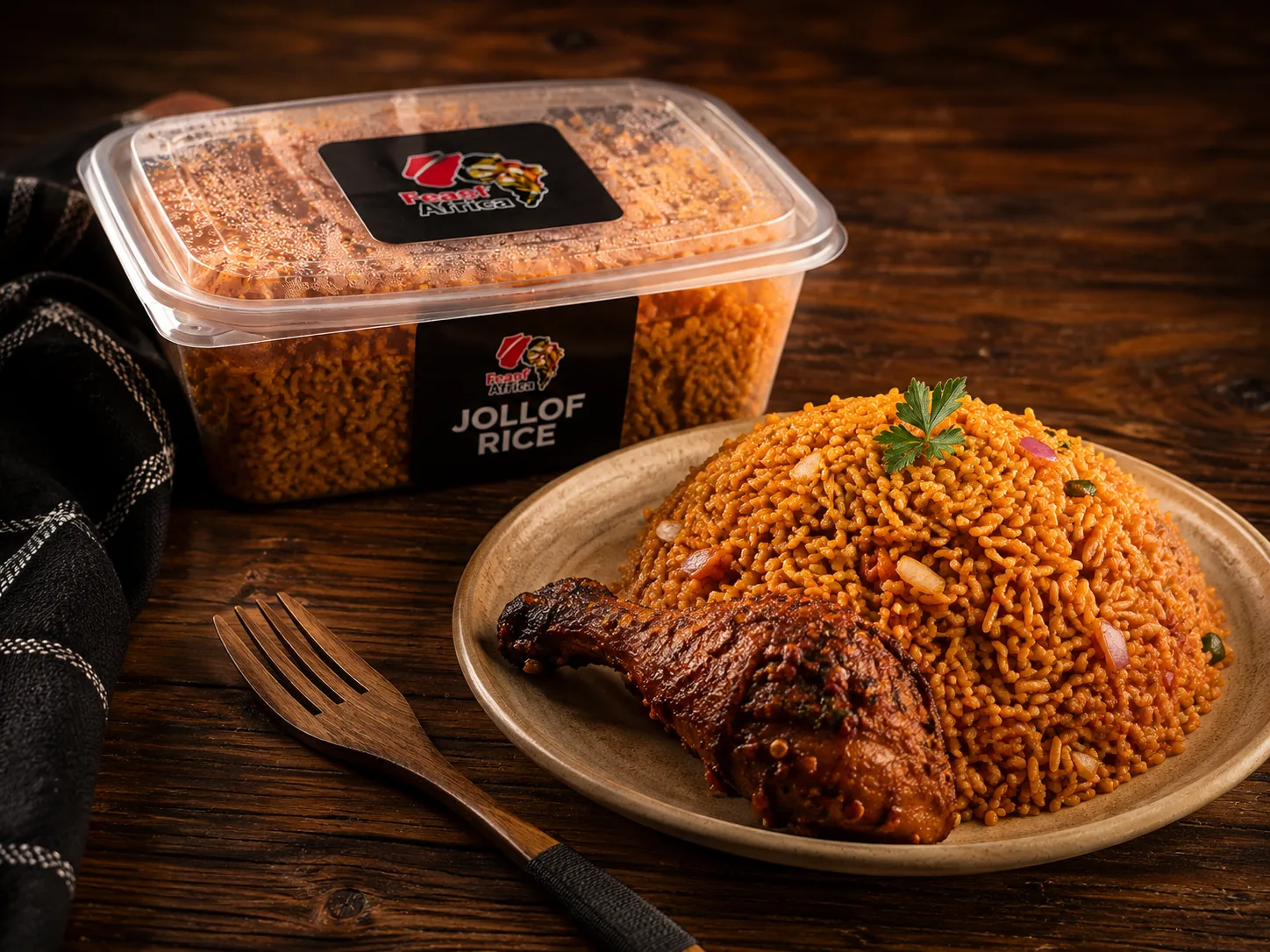 Feast of Africa jollof rice in its branded box beside a served plate